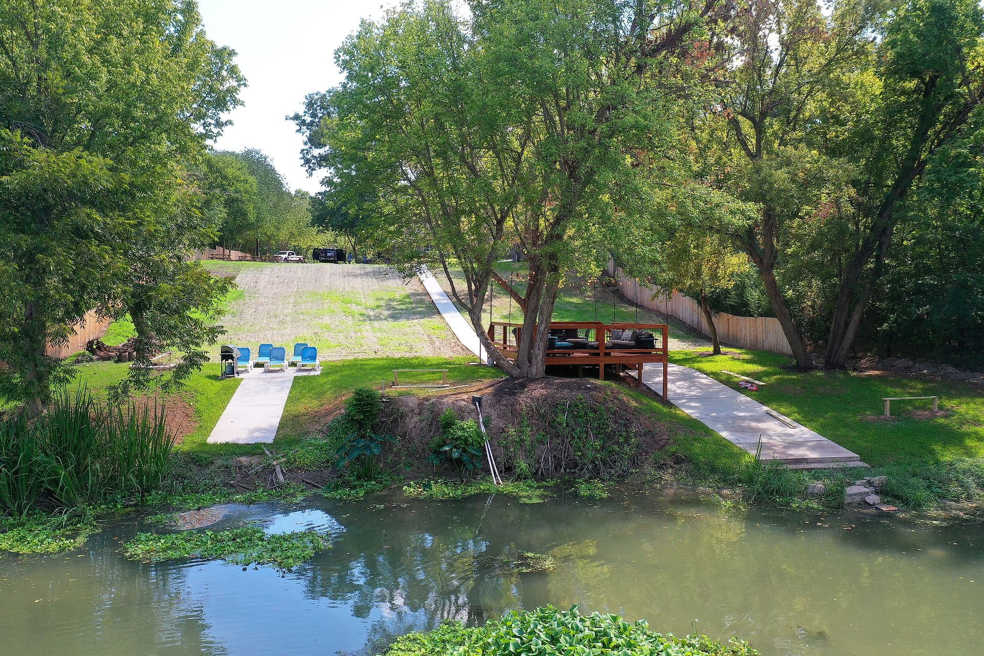 Aerial view of River Bend Bliss showing the lawn, viewing deck and the Colorado River in Cedar Creek, Texas