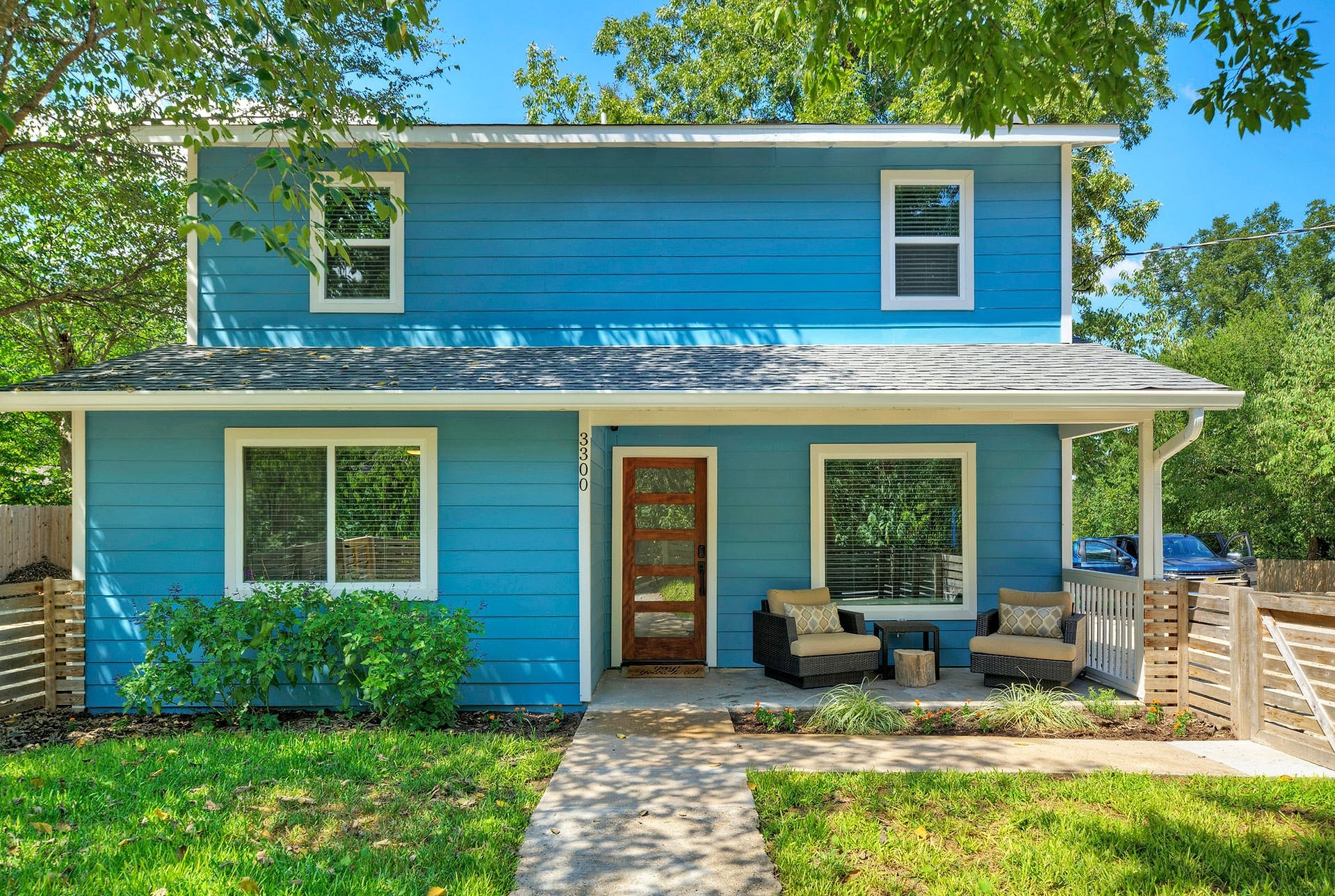 Front of the renovated blue River Bend Bliss house with covered porch