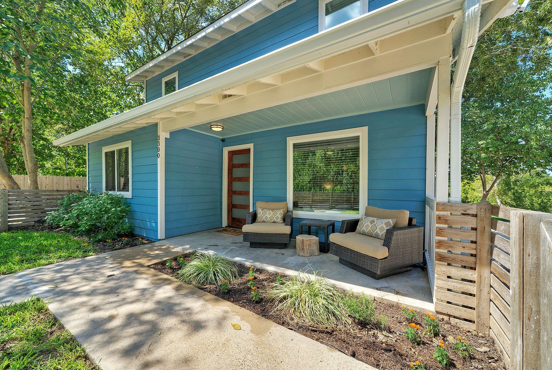 Covered front porch with outdoor seating at the River Bend Bliss house