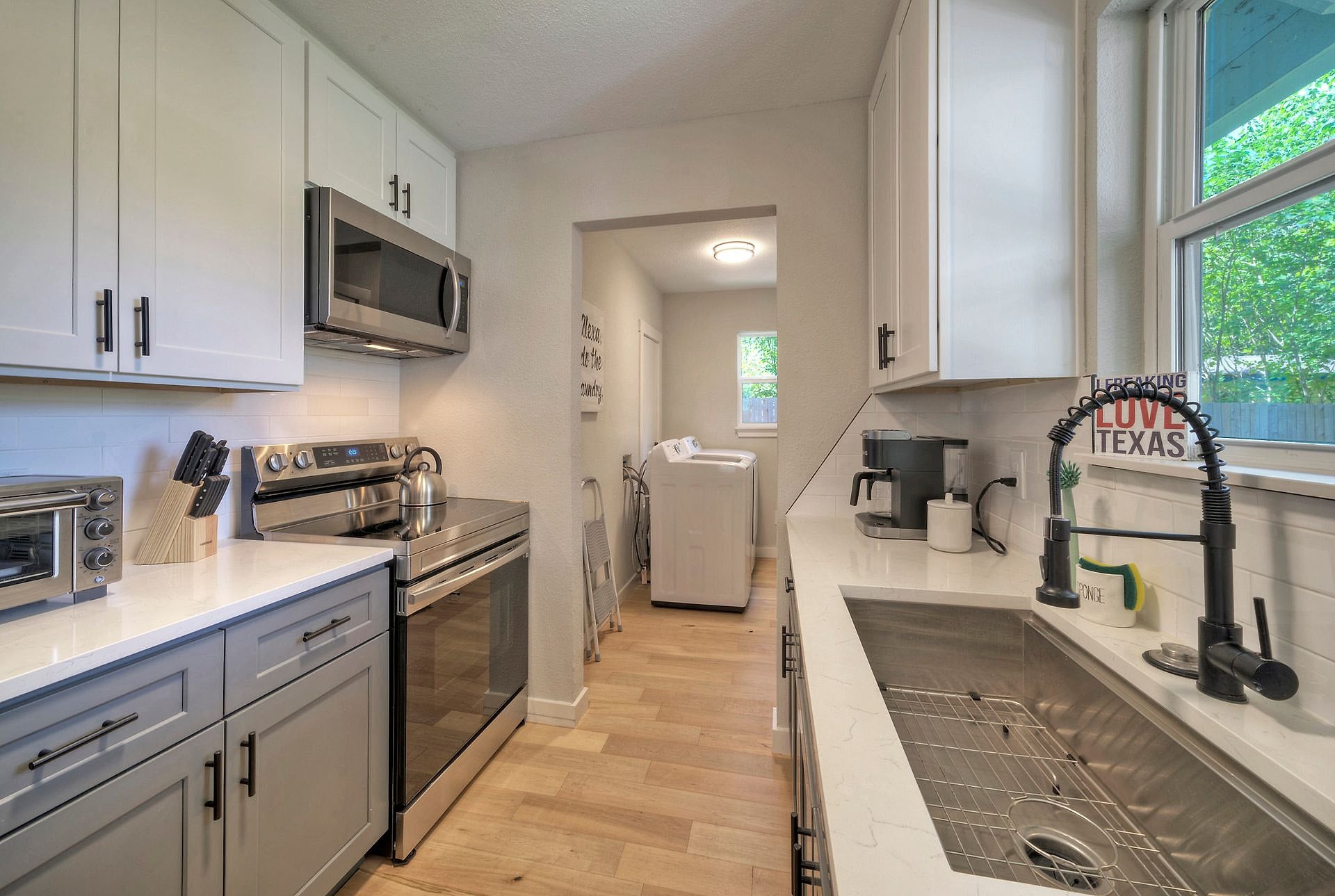 Renovated kitchen with white cabinets and stainless appliances in the river house