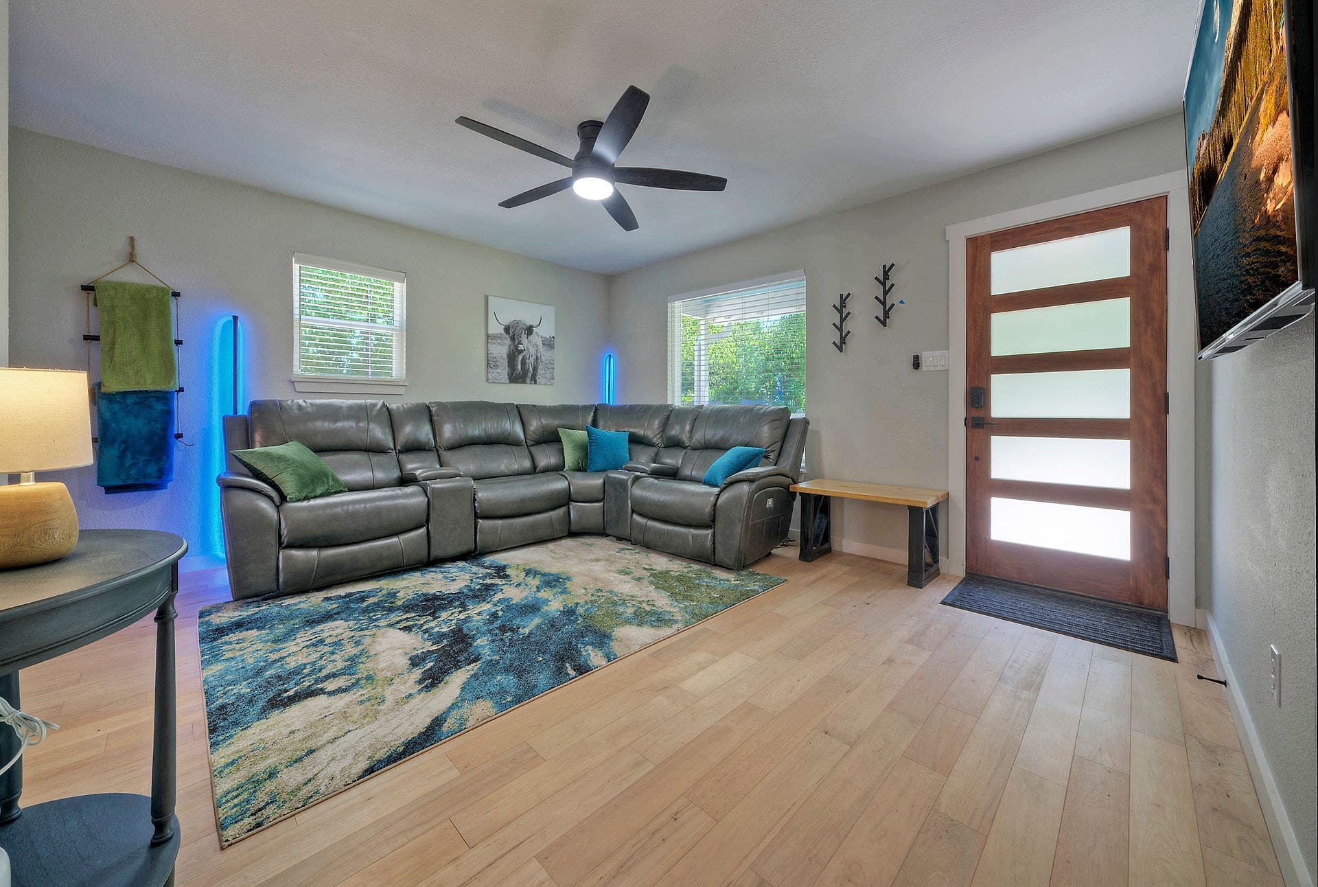 Open living room with sectional sofa and large TV in the Cedar Creek vacation rental