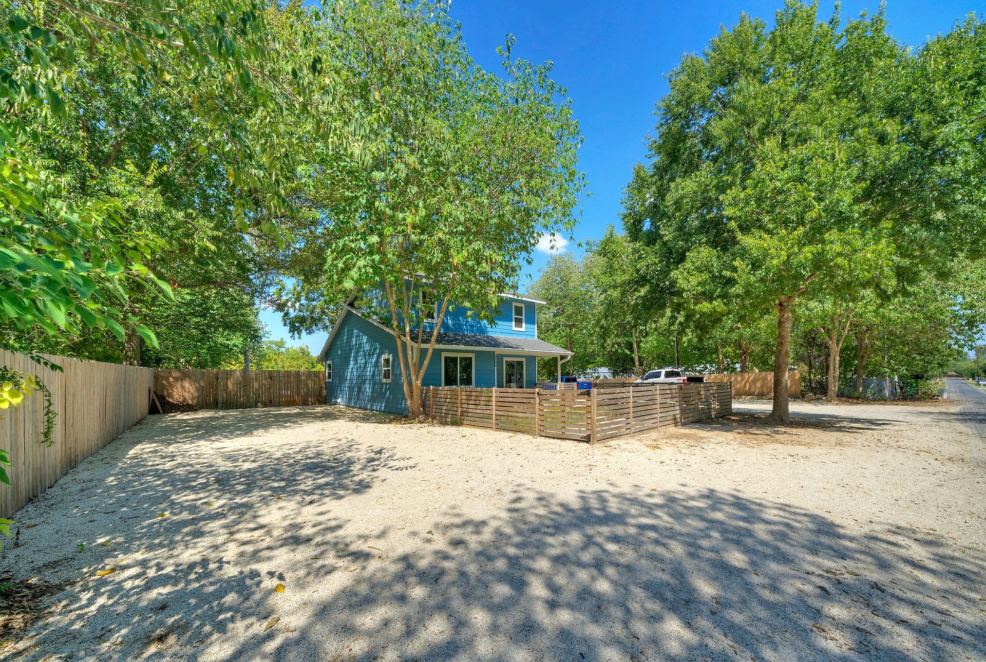 Gravel RV sites with full hookups beside the river house in Cedar Creek, TX